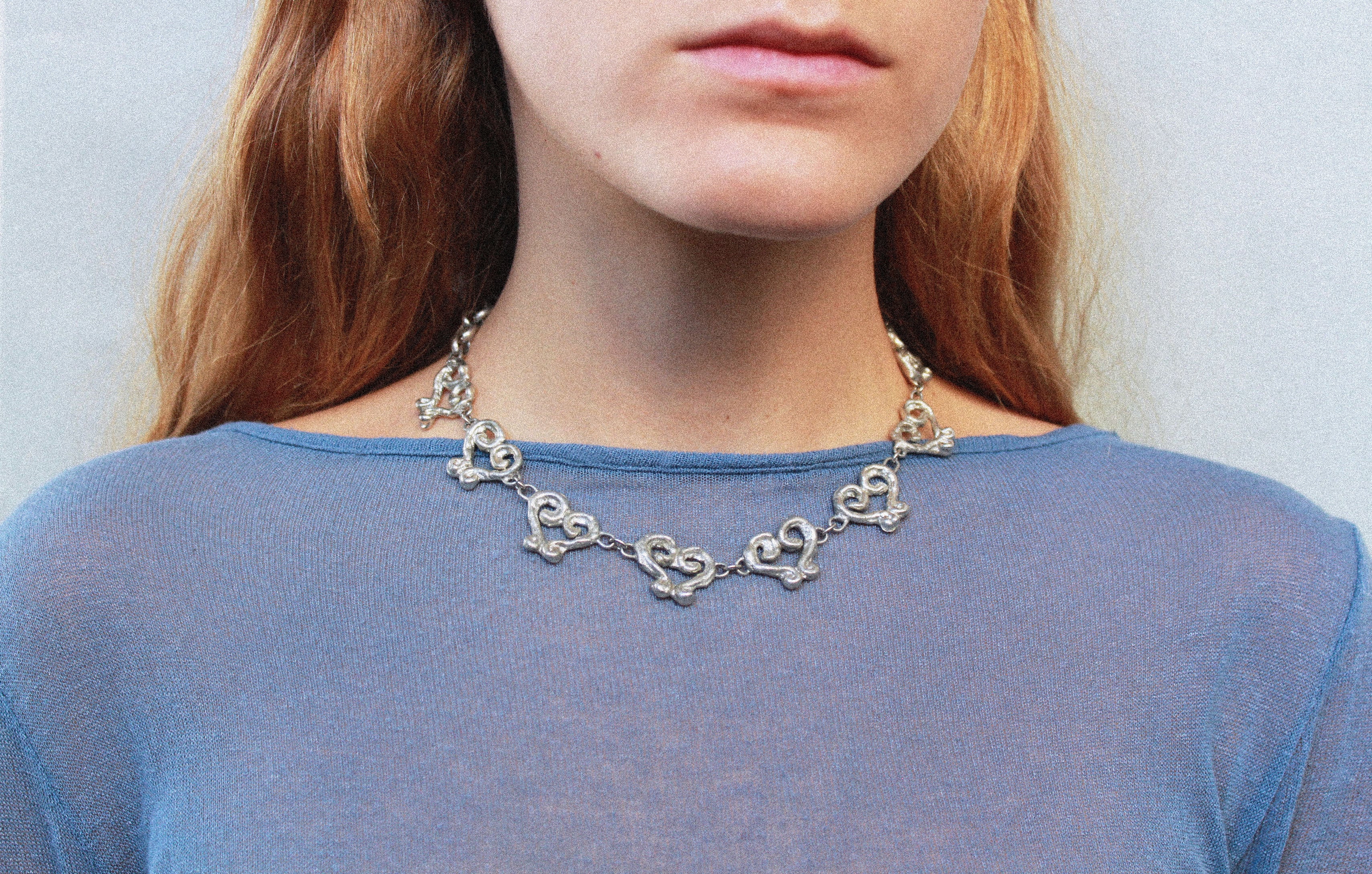 close up collier coeur en étain argenté fondu individuellement à la commande selon un procédé artisanal unique mis en place par la marque de bijoux Lolie